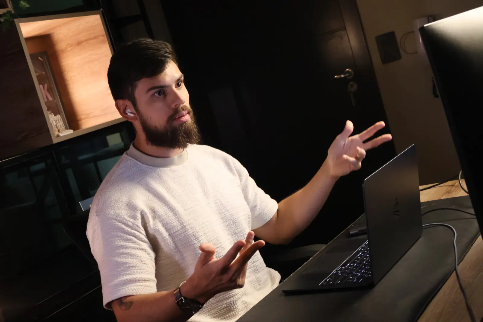 Ian Galeno gesticulando enquanto explica, sentado em frente ao notebook